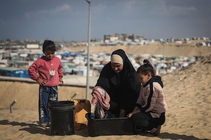 Una mujer palestina desplazada lava ropa en un campamento improvisado en la frontera con Egipto, al oeste de Rafah, en el sur de Gaza.