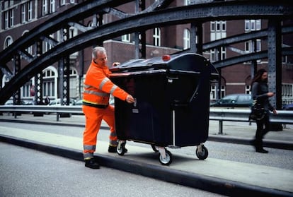 El empleado de recogida de basuras de Hamburgo, Hans-Dieter Braatz realiza una fotografía con el contenedor 'tuneado' en cámara de fotos.