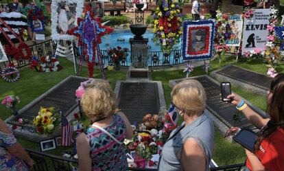 Elvis Presley fans visit his grave in Memphis on August 12.