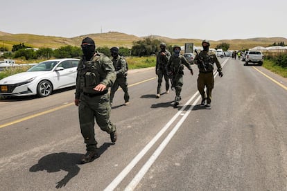 Israeli gather near the Hamra junction in the northern part of the Jordan valley in the occupied West Bank following a shooting attack on April 7, 2023