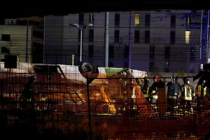 Rescue personnel work at the site where a passenger bus with people on board fell from an elevated section ending up on the railway track that runs alongside the road in Mestre, near Venice, Italy, 03 October 2023.