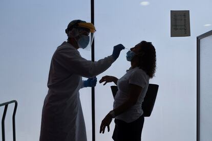 A health worker carries out a PCR test in Zargoza, Aragón, one of the regions hardest hit by the spike in Covid-19 cases.