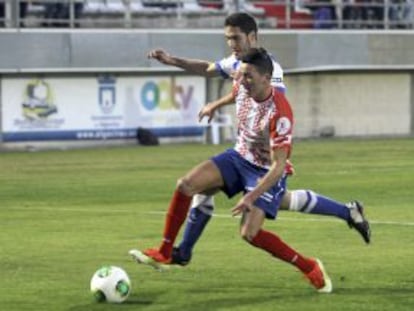 El centrocampista del Algeciras Jesús Ayala lucha un balón con Elustondo.