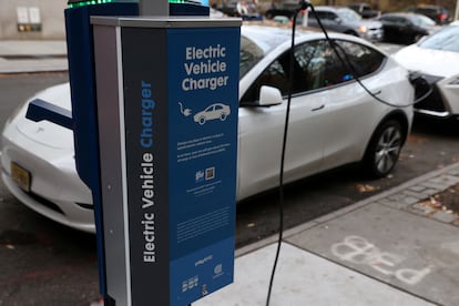 A electric vehicle charger is seen as a vehicle charges in Manhattan, New York, U.S., December 7, 2021