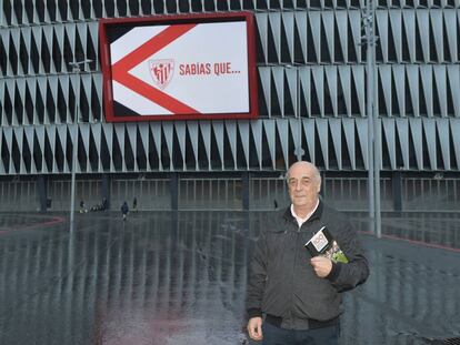 Eduardo Rodrigálvarez posa con uno de sus libros delante del estadio de San Mamés.