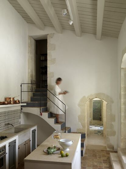 La cocina está pavimentada con cerámicas de Marruecos. Y la zona de aguas y fuego está protegida por baldosas sicilianas recuperadas. La escalera conduce a la despensa. 
