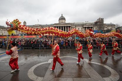 Varios pasacalles de la danza del dragón chino caminan durante las celebraciones del Año Nuevo Chino en la Plaza Trafalgar, Londres (Inglaterra).