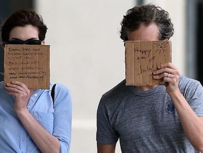 Anne Hathaway y su marido, Adam Shulman, enarbolan mensajes de apoyo a ONG ante los fot&oacute;grafos.