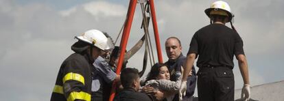 Rescuers pull a passenger from last week's train wreck in Buenos Aires that left 51 dead.