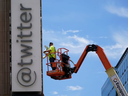 A workman removes a character from a sign on the Twitter headquarters building in San Francisco, Monday, July 24, 2023.