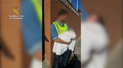 A Civil Guard officer with the rescued baby.