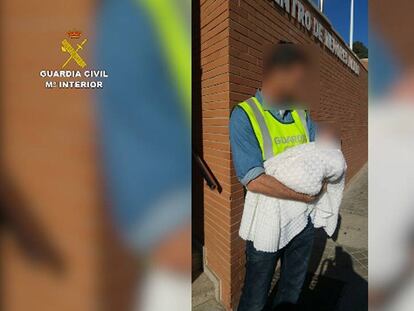 A Civil Guard officer with the rescued baby.