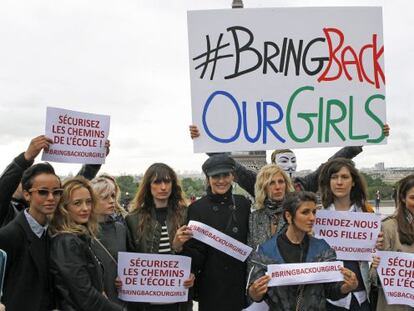Actrices y modelos francesas posan frente a la Torre Eiffel con pancartas para mostrar su apoyo a la liberación de las niñas secuestradas en Nigeria.