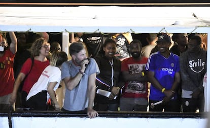 Migrants stand on the ‘Open Arms’ rescue ship before disembarking at Lampedusa.