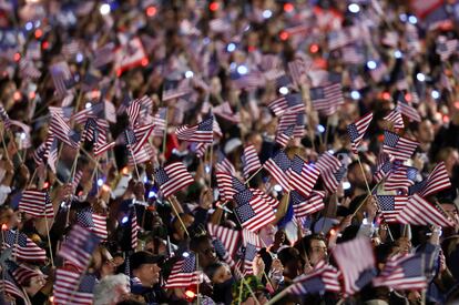 Supporters wave American flags while attending Democratic presidential nominee U.S. Vice President Kamala Harris' campaign event.