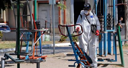 A worker wearing a protective suit sprays disinfectant at a children's park during a campaign to sanitize public spaces as a preventive measure against the spread of the new coronavirus, COVID-19, in Guadalajara, Mexico, on March 23, 2020. - The number of deaths around the world from the novel coronavirus now stands at 16,146, according to a tally compiled by AFP at 1900 GMT Monday from official sources. More than 361,510 declared cases have been registered in 174 countries and territories since the epidemic first emerged in China in December, though that figure likely reflects only a fraction of the actual number of infections. (Photo by ULISES RUIZ / AFP)