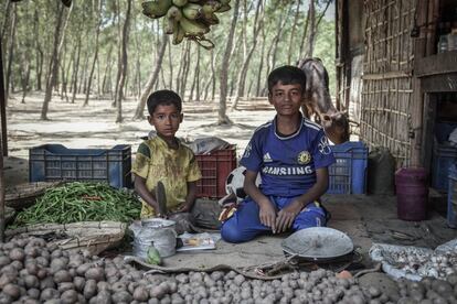 Dos niños venden verduras en el mercado del campo de refugiados de Leda, en el sureste de Bangladesh, que alberga a rohinyás indocumentados. Para muchas familias, los niños se convierten pronto en potenciales ganadores de dinero, así que se prioriza que trabajen de alguna manera en lugar de su educación.