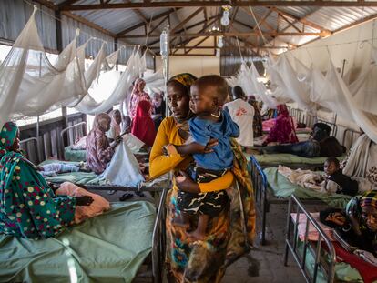 Una mujer carga con su hijo enfermo de malaria en un hospital de la ciudad de El Fasher, en el estado sudanés de Darfur Norte, en octubre de 2019.