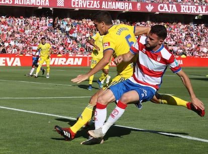 Garrido pelea el balón con Quini. 