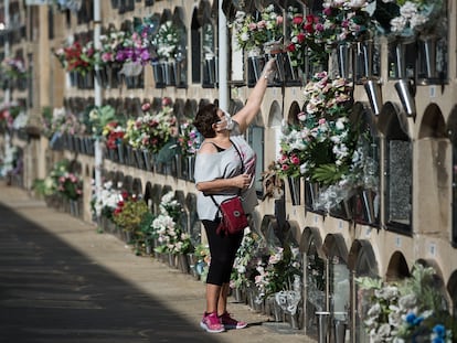 A woman leaves flowers at the Poblenou cemetery in Barcelona.