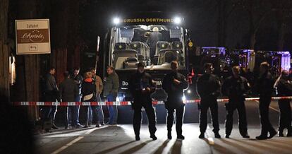 Police standing guard in front of the BVB team bus.