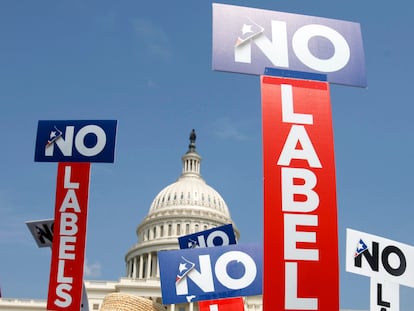 FILE - People with the group No Labels hold signs during a rally on Capitol Hill in Washington, on July 18, 2011.