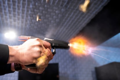 A semi-automatic pistol with a conversion device installed making it fully automatic is fired as four empty shell casings fly out of the weapon, at the Bureau of Alcohol, Tobacco, Firearms, and Explosives (ATF).