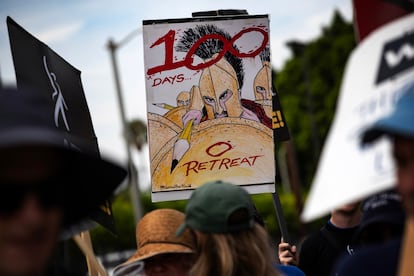 A demonstrator holds a poster reading '100 days 0 retreat' as members of the Writers Guild of America (WGA) protest in front of the Paramount studios in Los Angeles, California, USA, 09 August 2023.