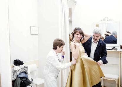 El modista hace una prueba con uno de sus vestidos, en mikado doble de seda natural, a la actriz Malena Alterio, ayudado por Pilar Yagüe, una de las oficiales de su taller.