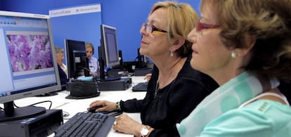 Dos usuarias del EspacioCaixa Madrid participan en un curso de retoque fotogr&aacute;fico.