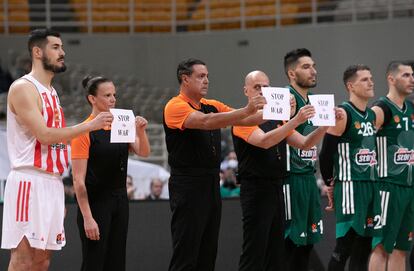 Árbitros y jugadores con carteles contra la guerra en un partido de Euroliga entre el Panathinaikos y el Estrella Roja.