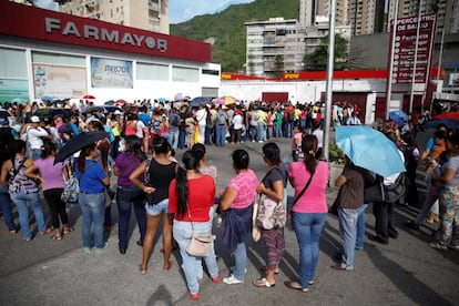 Grupo de personas haciendo cola para comprar papel higiénico y pañales en Caracas.