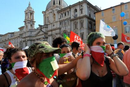 Pañuelos con los colores de la bandera italiana cubren los rostros de varios manifestantes en Roma.