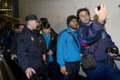 Alves se fotografía con un aficionado a la salida de la estación de Delicias, de Zaragoza, desde la que el Barça viajó en autocar hasta Pamplona.
