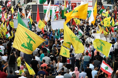 Supporters of Hezbollah wave Palestinian, Lebanese and Hezbollah flags during a protest in solidarity with Palestinians, in Beirut (Lebanon), on October 27, 2023.