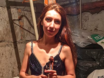 CORRECTS SPELLING OF NAME   Vera Lytovchenko holds her violin as she poses for a photo in a basement of an apartment building in Kharkiv, Ukraine, Sunday March 6, 2022. Lytovchenko is Ukraine's cellar violinist, who has become an internet icon of resilience as images of her playing in the basement bomb shelter have inspired an international audience via social media. (Vera Lytovchenko via AP)