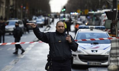 Un policia desvia el trànsit a la zona acordonada.