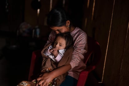 Cristina Moreno, de 18 años, con su bebé en su casa de Juvinani. La vivienda está parcialmente edificada con ladrillos de lodo y estiércol de bestias de carga, como la mayoría en esta área. Los niños merodean junto a perros famélicos rodeados de moscas.