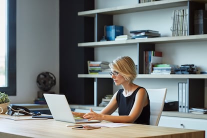 Businesswoman using laptop in textile factory