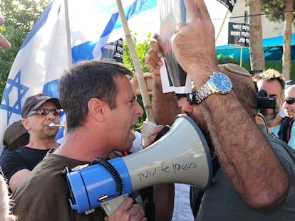 Manifestante y contramanifestante en una protesta sobre la exención del servicio militar de los ultraortodoxos, este jueves en Jerusalén.