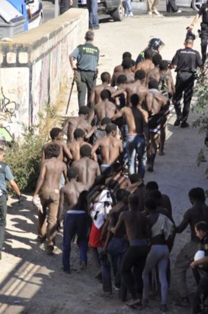 Sub-Saharan migrants captured after jumping into Melilla.