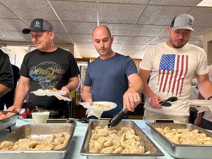 Maksym Bunchukov, Andrii Hryshchuk and Ivan Sakivskyi help themselves to perogies at a lunch hosted Monday, July 17, 2023, by the Ukrainian Cultural Institute in Dickinson, North Dakota