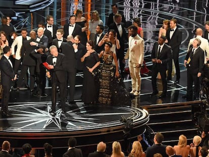 Los equipos de las pel&iacute;culas &#039;La La Land&#039; y &#039;Moonlight&#039;, en el escenario tras anunciarse que la pel&iacute;cula ganadora no es el musical del director Damien Chazelle, sino el drama dirigido por Barry Jenkins. En el centro de la imagen, Warren Beatty, con el sobre en la mano.