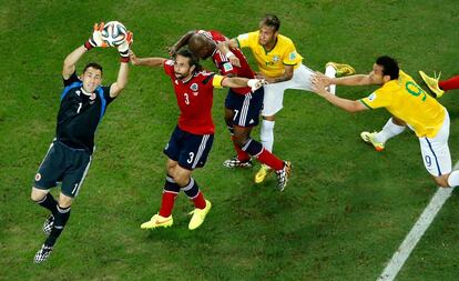 El guardameta colombiano David Ospina se hace con el bal&oacute;n, protegido por el defensa de su equipo Mario Yepes. 