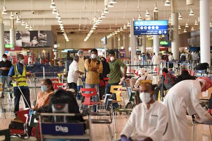 Ciudadanos indios esperan a embarcar, este jueves en el aeropuerto de Dubái.