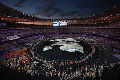 Deportistas de las diferentes delegaciones desfilan por el Estadio de Francia.