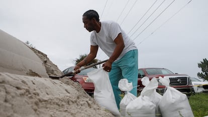 Lenard Cox prepares sandbags before the expected arrival of Milton in Seminole, Florida on October 6, 2024.