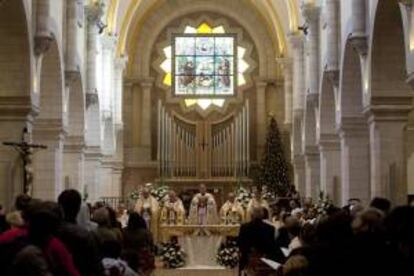El Patriarca Latino de Jerusalén, Fuad Twal (c), oficia la Misa del Gallo en la Basílica de la Natividad en Belén, Cisjordania. En este templo se encuentra la Gruta de la Natividad, donde se sitúa el nacimiento de Jesús. EFE/Archivo