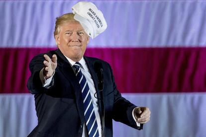 President-elect Donald Trump throws a hat into the audience while speaking at a rally in a DOW Chemical Hanger at Baton Rouge Metropolitan Airport, Friday, Dec. 9, 2016, in Baton Rouge, La. (AP Photo/Andrew Harnik)