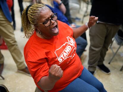 Volkswagen automobile plant employee Vicky Holloway celebrates as she watches the results of a UAW union vote, late Friday, April 19, 2024, in Chattanooga, Tenn.